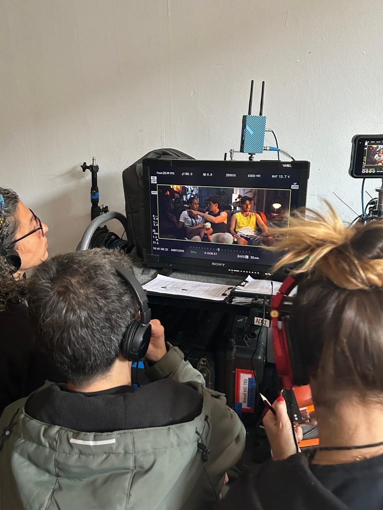Crew reviewing intimate scene footage on professional monitor