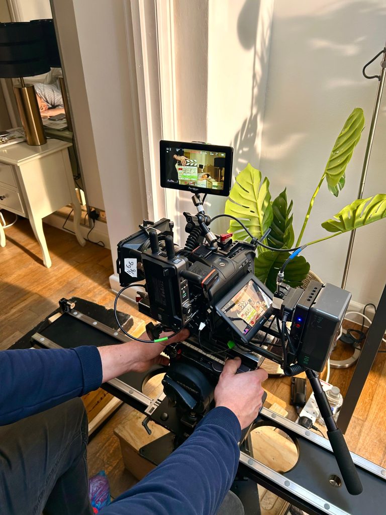 Professional camera operator with cinema camera rig in studio